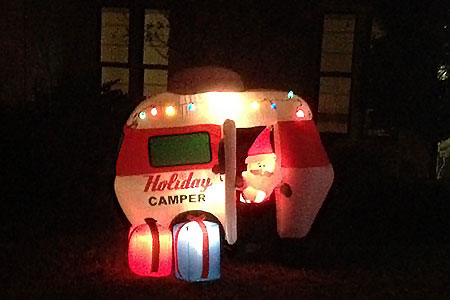 Air filled holiday decoration of a camper with Santa inside