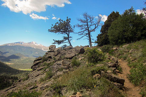 Trail leading to outcropping with view of Longs Peak